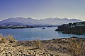 Asteri Dam or Parapiros Dam. View of the dam lake. The temporary islet with Saint Theodores' chapel of Mitopolis village is sinking. The numerous peaks of Mt. Erymanthos can be seen in the background.