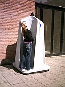 Woman uses an outdoor portable urinal