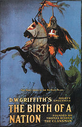 The theatrical poster for The Birth of a Nation depicting a hooded man carrying a burning cross on horse back.