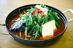 Korean maeuntang (spicy fish soup) with crown daisy
