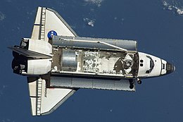 Top view of a spaceplane above the Earth.