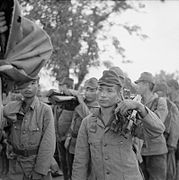 Japanese troops of 52nd Division hand over weapons.jpg