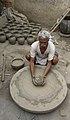 Image 10 Potter Photo: Yann A potter at work in Jaura, Madhya Pradesh, India. Pottery, defined by ASTM International as "all fired ceramic wares that contain clay when formed, except technical, structural, and refractory products", originated during the Neolithic period. More selected pictures