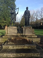 Two bronze sculptures on a stone base