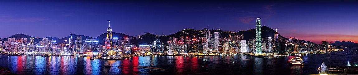 Skyline at night, with building lights reflected in water