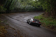 A DeLorean car on a banked turn