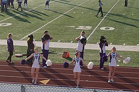 Cheerleaders cheering on the crowd.