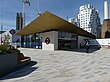 A single-storey building with a wide projecting canopy with the Underground sign on the side