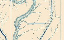 A gold-brown colored map with a road and a lake on it