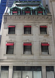 Detail of the Holbrook House facade, which contains a mansard roof above the limestone facade