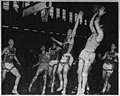 Leroy Chollet (center) defends a jumpshot