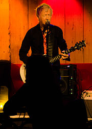 An older man playing a guitar