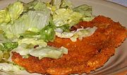 Polish kotlet z kurczaka breaded chicken cutlet with cabbage salad.