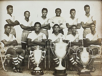 The Ghana national team of the 1960s poses with some trophies