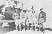 Major Rayma L. Andrews (far right), a Mexican colonel and two pilots wearing goggles during the siege of Naco, Sonora, on April 4, 1929. Both of the pilots were shot down and killed on the following day.