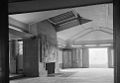 Hollyhock House living room, with fireplace and skylight (toward the southeast, 1965) The fireplace hood features a geometric sculptured relief by Wright.