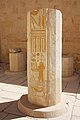 The lower section of a column, still standing, with many hieroglyphs and the painting of an individual