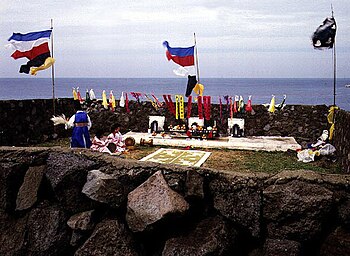 An outdoor shaman ritual, with several flags and banners.