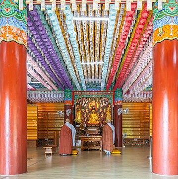 Interior view of Beomeosa temple with two Buddhist monks in Busan South Korea