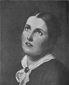 A young white woman, eyes cast upward, hair parted center and dressed back to the nape, wearing a white kerchief fastened with a pin at her throat