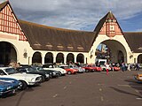 View of part of the crescent-shaped indoor market building during a vintage car session