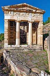 Ancient Greek Doric columns and entablature of the Athenian Treasury, Delphi, Greece, unknown architect, c.525 BC[15]