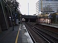 train platform at Denmark Hill station with King's College Hospital tower in the background