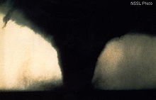 Photograph of a dark funnel cloud