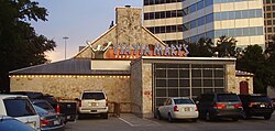 Photograph of a building's exterior from a parking lot