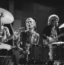 Black and white image of Baker playng an elaborate drum kit