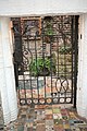 Gate with colorful paving elements