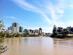 Itajai-Acu river seen frae the surroondins o Garcia's stream mooth; ceety centre at left