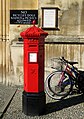 A Victorian hexagonal red post box of the Penfold type manufactured in 1866 outside King's College, Cambridge (not the original location for this box).