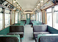 Inside a COP trailer, which always was for 3rd class pasengers only. Note the decorative 'half moon' shaped glass on some of the seat backs.