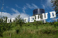 Kota Belud town sign on a hill.