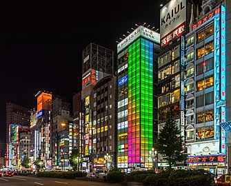 Colorful illuminated facades of buildings at night, with green, blue and pink lights, Kabukicho, Shinjuku, Tokyo