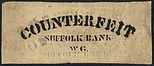 A rectangular piece of paper. Counterfeit is printed on the top. "Suffolk Bank" is in the middle, above "WG"