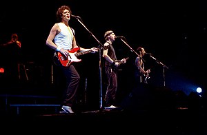 Image of four musicians on stage performing