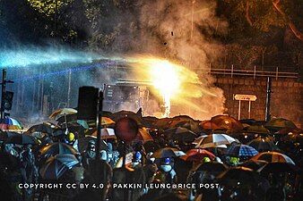 Police using a water cannon truck