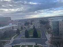 A photo taken from the seventh floor of the Fitzsimons building in 2021, facing south. The flag pole is seen in the foreground.