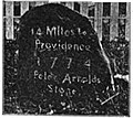 Peleg Arnold's 1774 milestone on old Great Road across from the Quaker Meeting House]