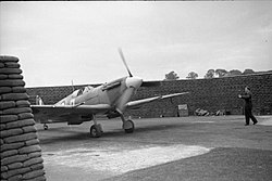 Circular airfield dispersal protected by a high wall of filled sandbags in a C layout