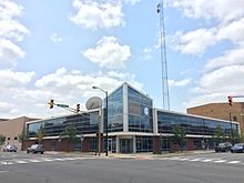 WNIT Center for Public Media in downtown South Bend. The building is made primarily of glass, and has a large screen displaying the live broadcast of WNIT's public television channel.