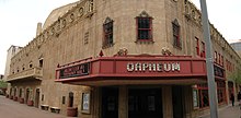 photo of the front entrance of the Orpheum theater, with the red marquee clearly displaying the Orpheum name, contrasted with the pale brown of the stone building