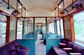 Inside a red P Stock train. The internal doorways (without doors) comes from when the District line included provision for 1st class pasengers - 1st class was split into two sections (smoking and non-smoking) and the rest of the carriage was for 3rd class passengers. 1st class was abolished in 1940 as a war-time economy.