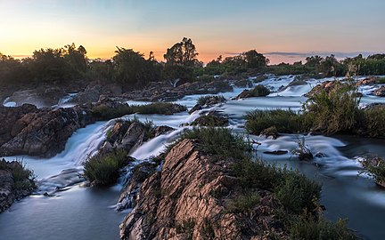 Li Phi falls at dusk with colorful sky in Don Khon Laos