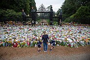 Flowers and cards in front of large gates