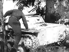 20:15 A crewman jumps aboard his snow-camouflaged tank