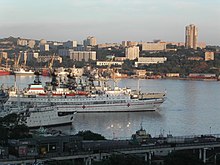 Ships in port, with modern buildings in the background