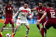 A Lebanese player surrounded by three Qatari defenders